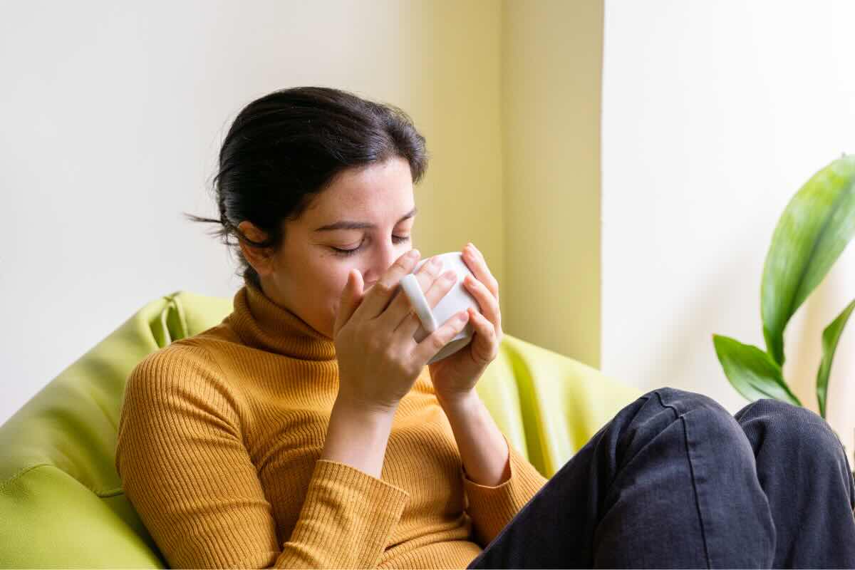 donna che beve dalla tazza