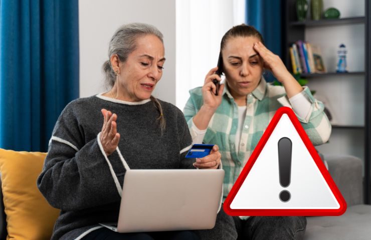 due persone al telefono davanti al computer e il simbolo di attenzione